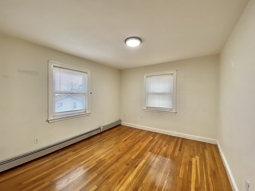 530 Beach Street, Unit 2 Revere, MA 02151 - Photo 6 of 7 a view of an empty room with wooden floor and a window