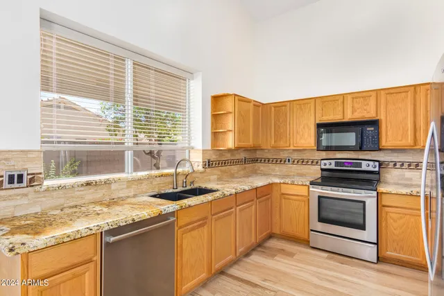 a kitchen with stainless steel appliances granite countertop a stove and a sink