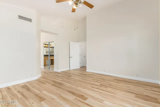 a view of empty room with wooden floor