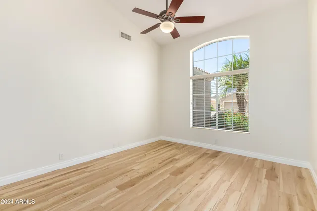 wooden floor in an empty room with a window