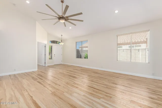 wooden floor in an empty room with a window