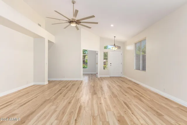 wooden floor in an empty room with a window