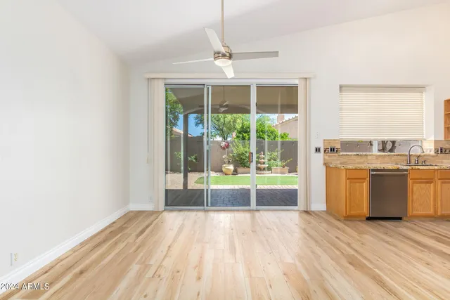 a view of a room with a sink and dishwasher with wooden floor