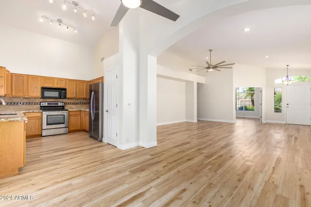 a view of kitchen view wooden floor and electronic appliances