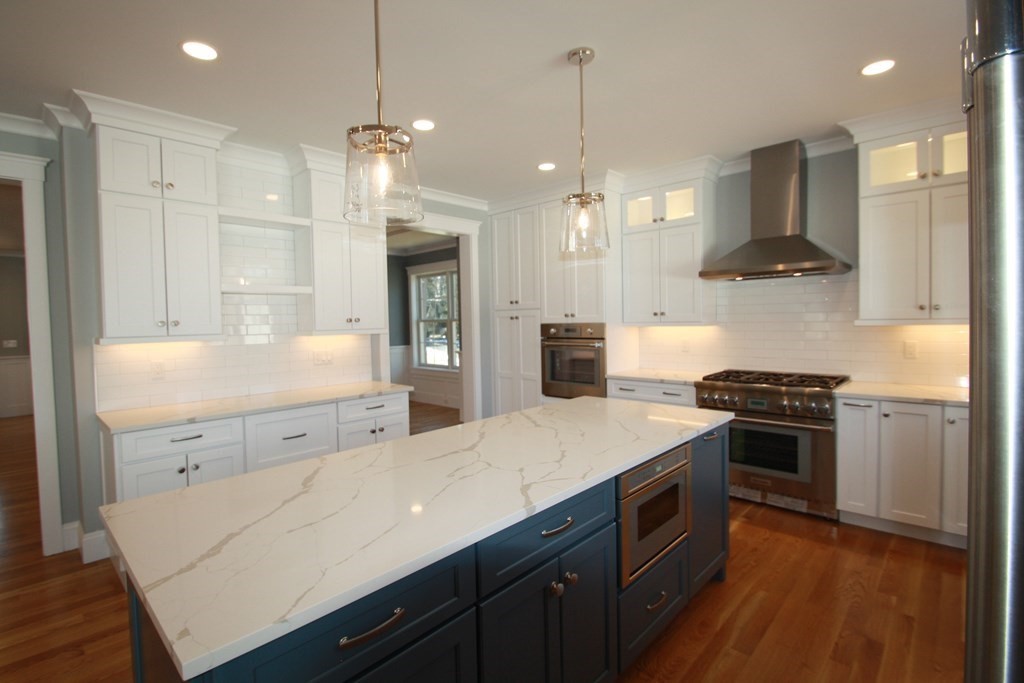31 Helen Road Needham, MA 02492 - Photo 4 of 11 a kitchen with a stove a sink and a refrigerator