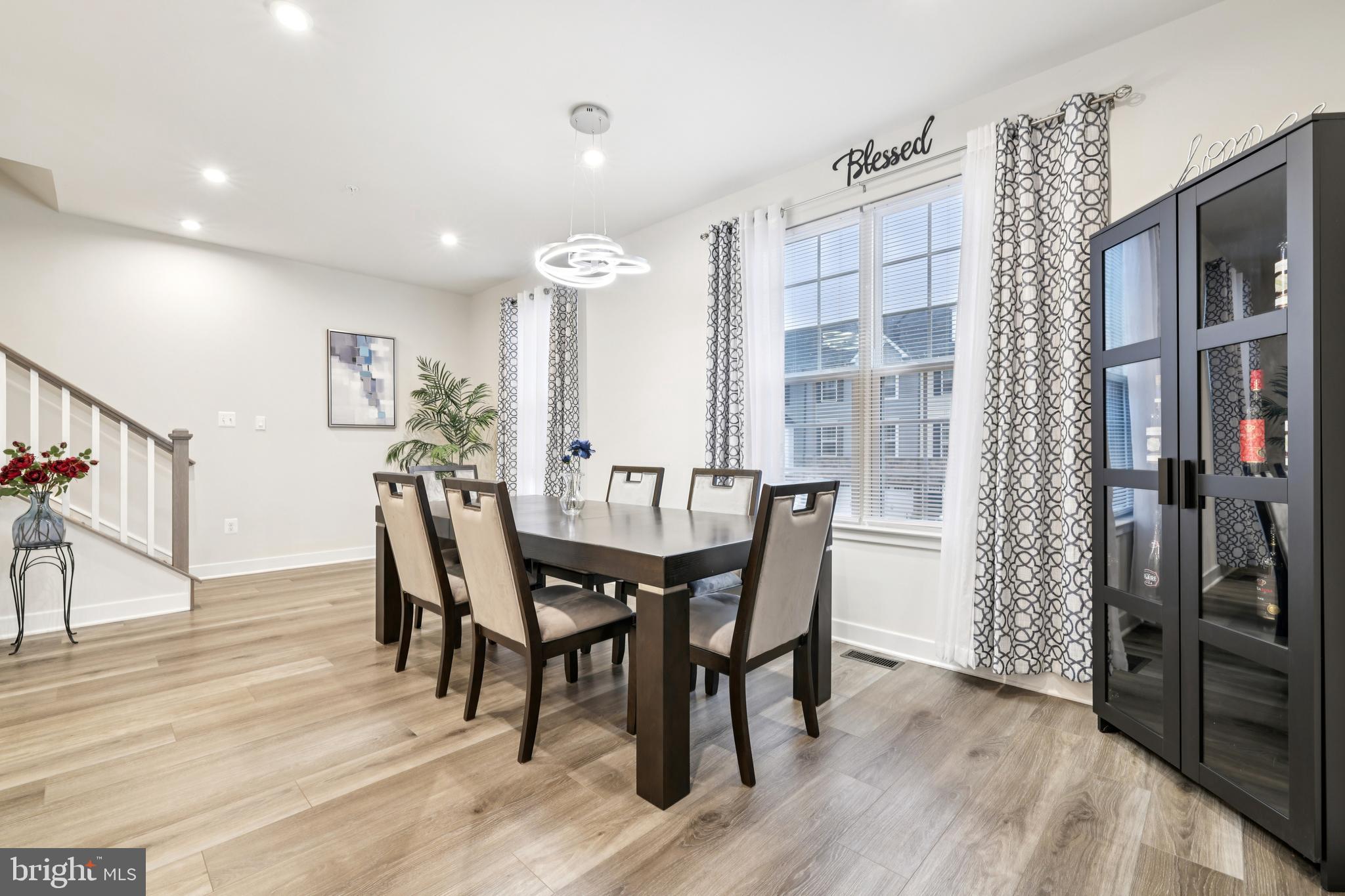 1716 Atlas Drive Frederick, MD 21702 - Photo 12 of 48 a view of a dining room with furniture and wooden floor