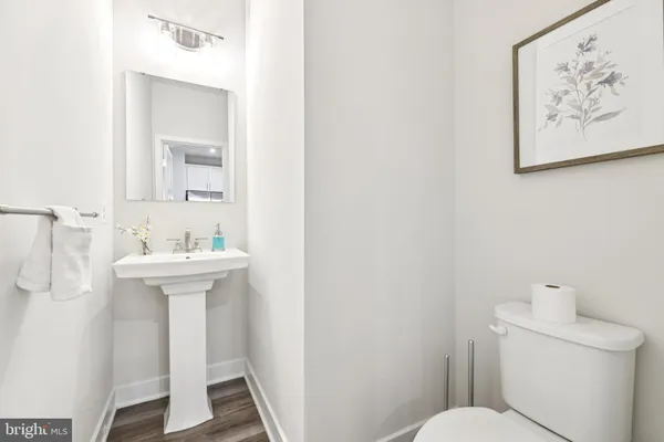 a bathroom with a sink toilet and a mirror