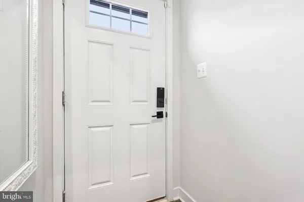 a view of a hallway with wooden floor and entryway