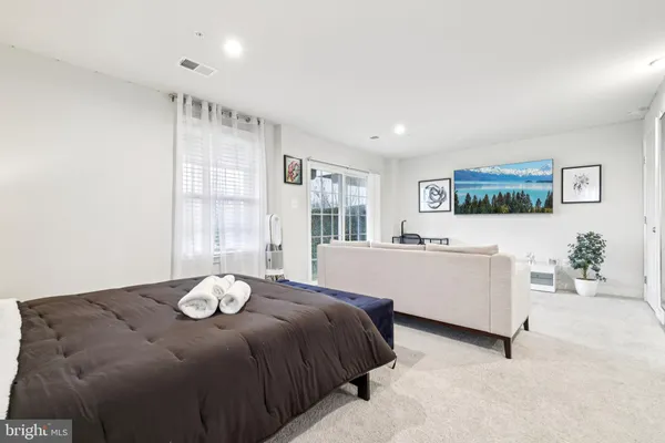 a kitchen with stainless steel appliances a sink a stove a microwave cabinets and a window