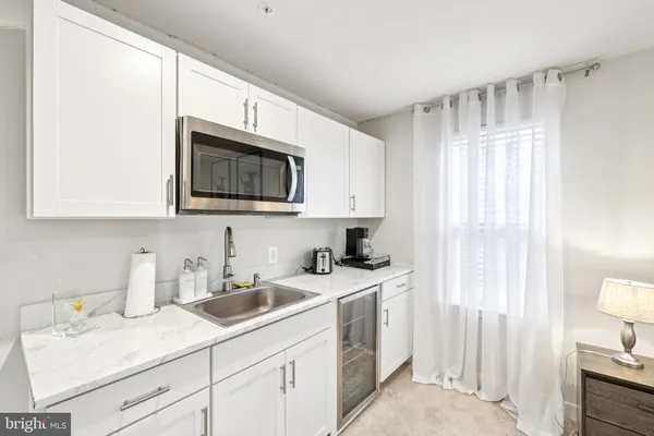 a living room with furniture a fireplace and a view of kitchen