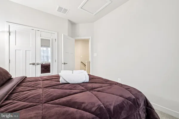 a bedroom with a bed and a couch