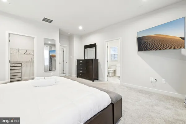 a bathroom with a sink toilet vanity and tub