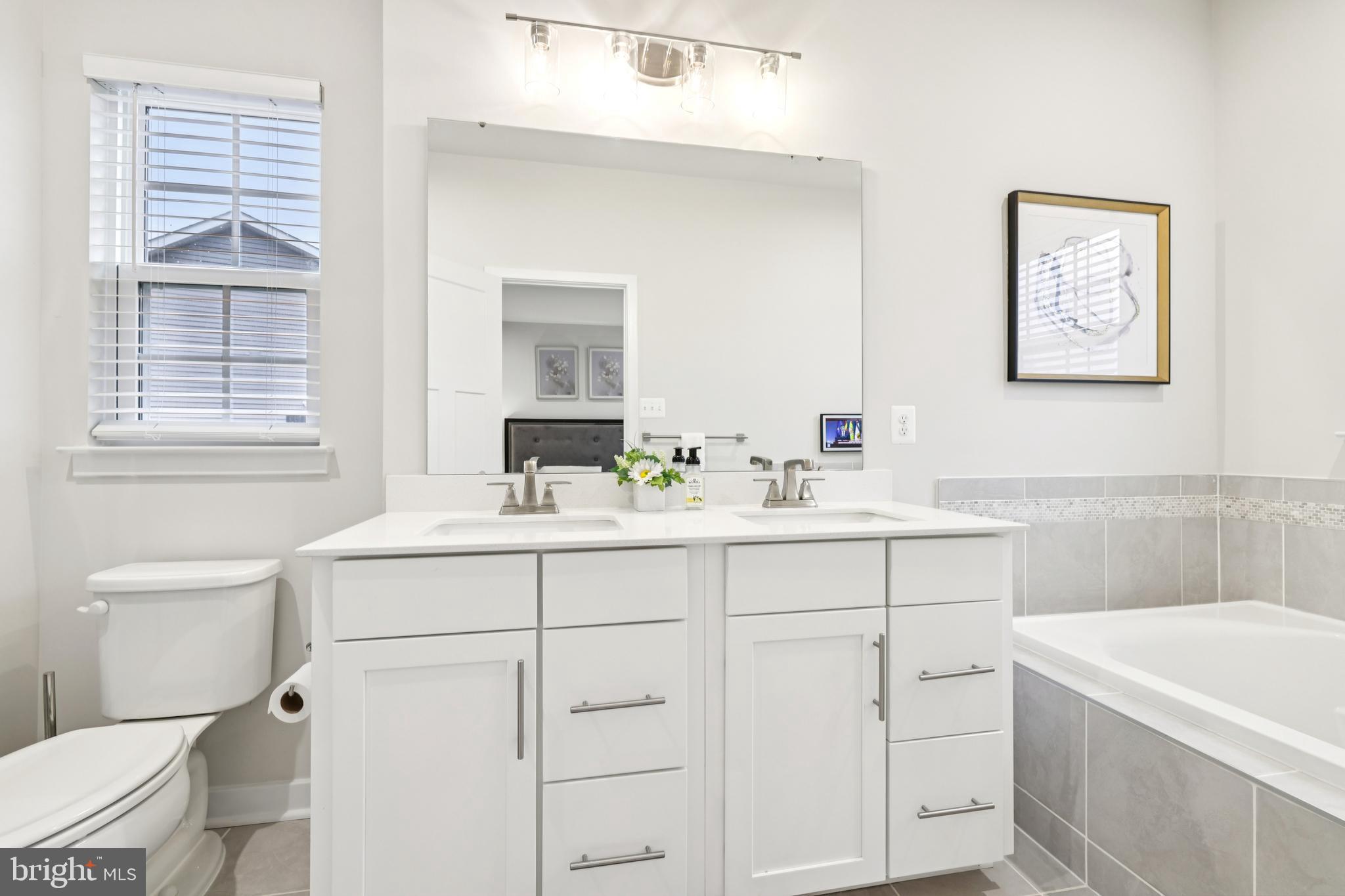 1716 Atlas Drive Frederick, MD 21702 - Photo 33 of 48 a bathroom with a sink toilet vanity and tub