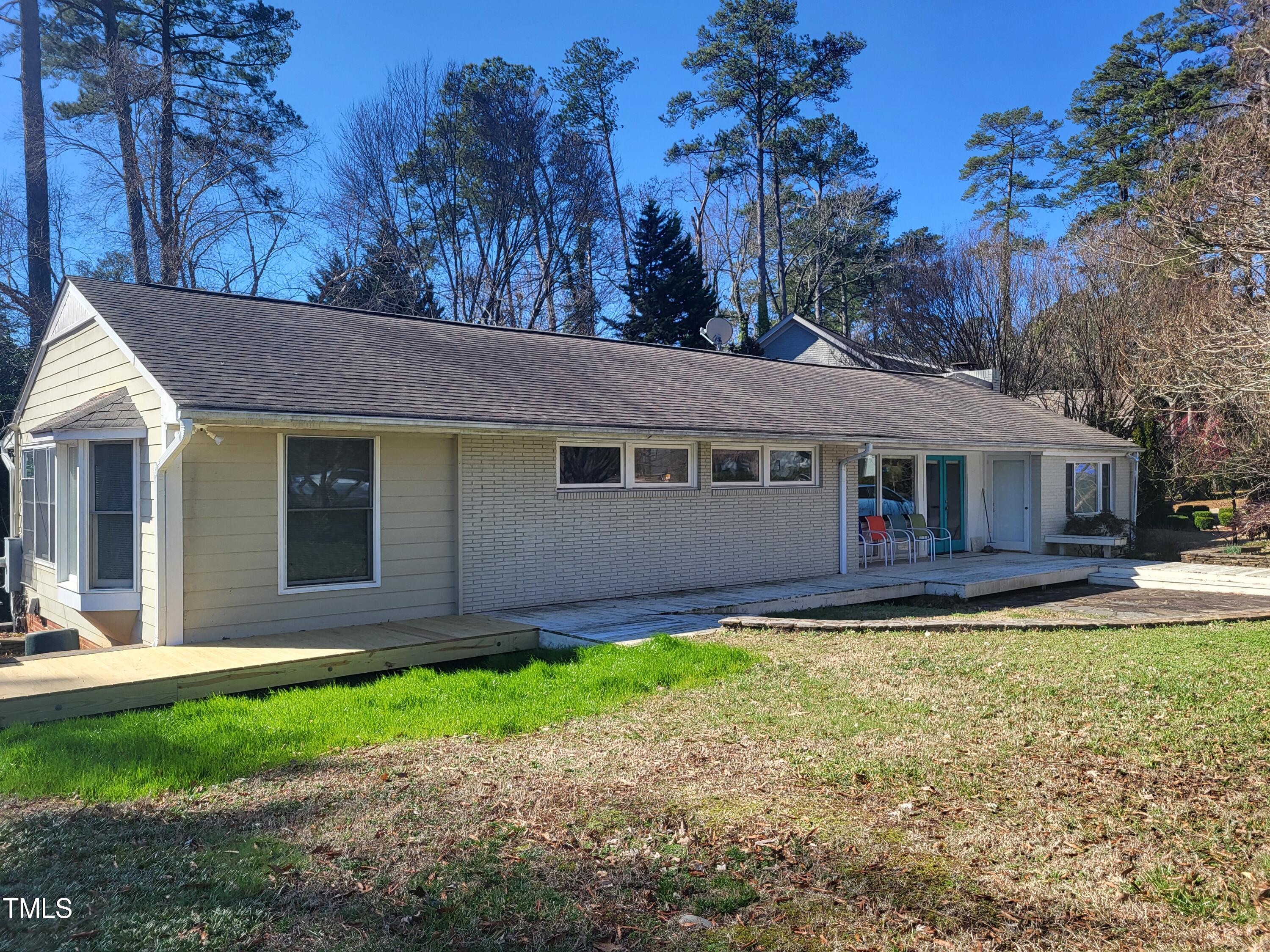 3403 Bradley Place Raleigh, NC 27607 - Photo 1 of 8 a front view of a house with a garden and yard