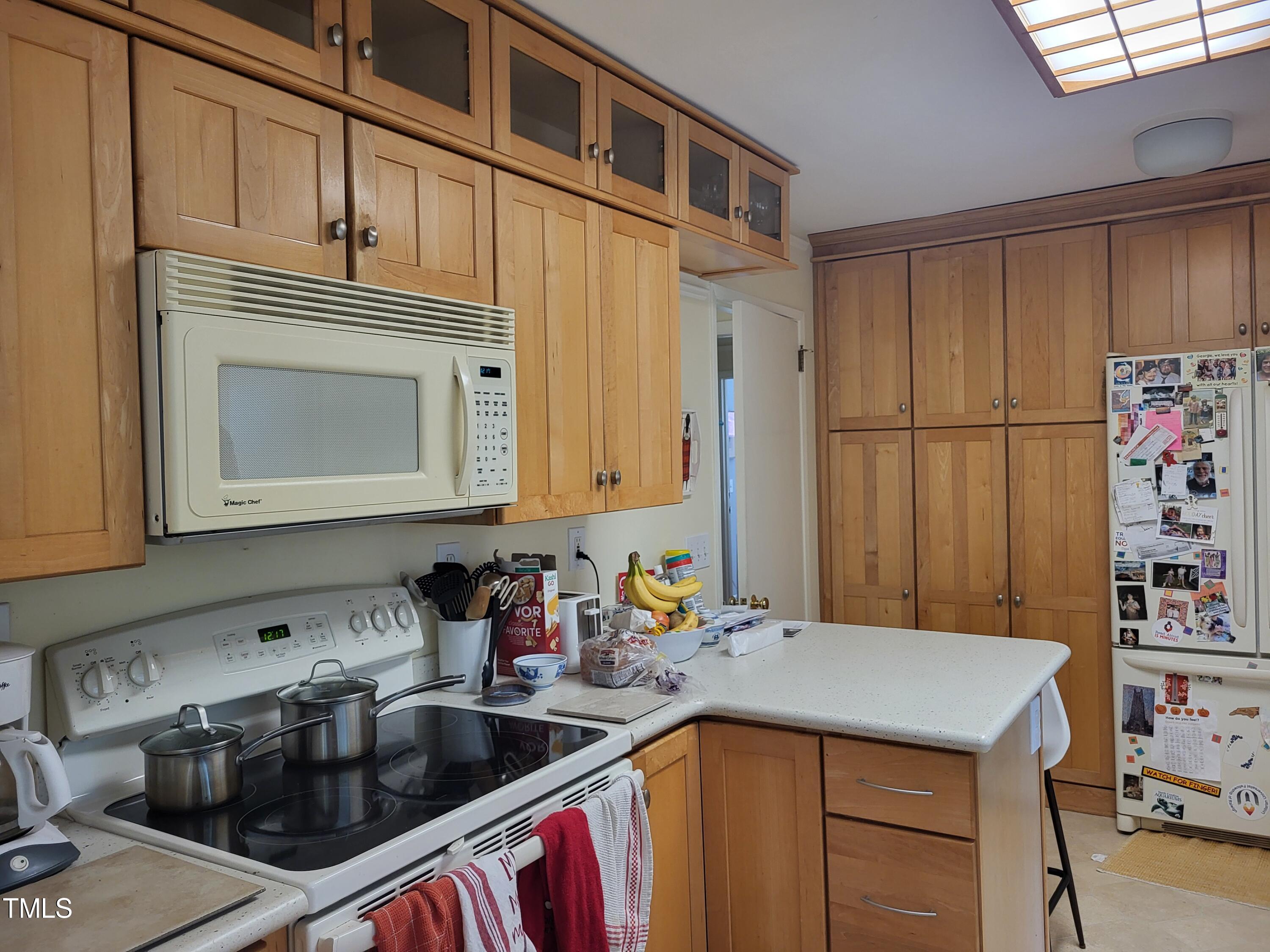 3403 Bradley Place Raleigh, NC 27607 - Photo 7 of 8 a kitchen that has a sink and a stove in it