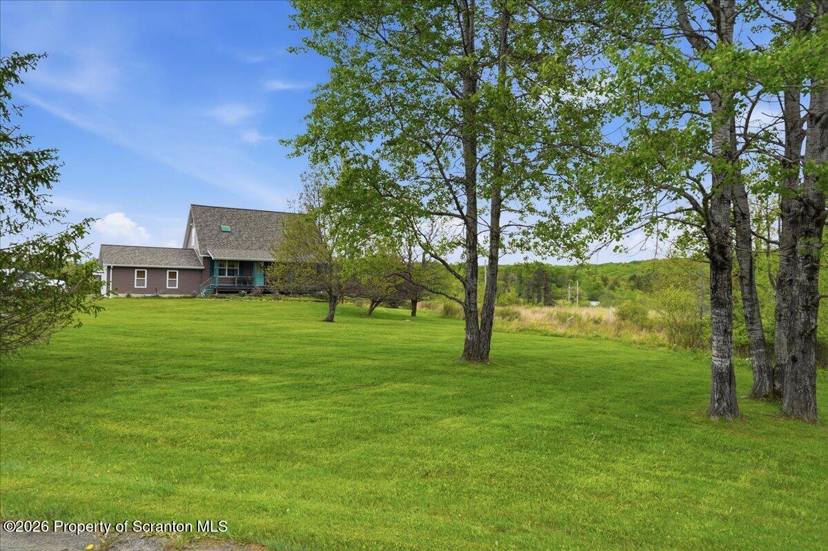 5231 Fiddle Lake Road Thompson, PA 18465 - Photo 31 of 34 a view of a house with a big yard