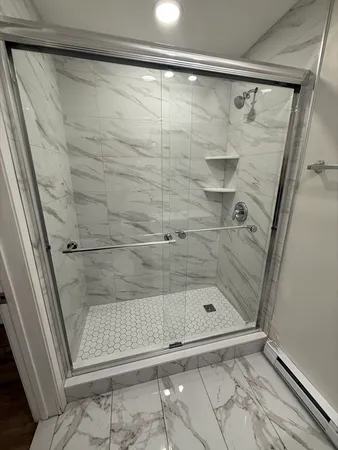 a bathroom with a glass shower door