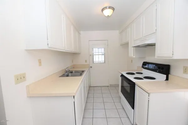 a kitchen with a stove and a sink