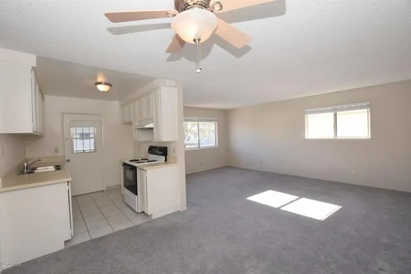 a kitchen with a chandelier fan and a stove