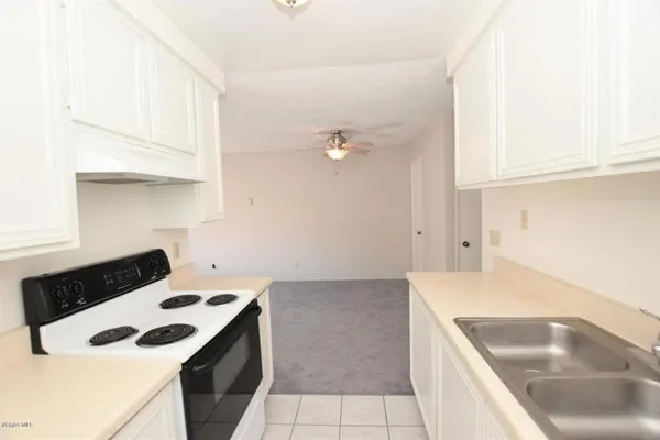a kitchen that has a sink and a stove