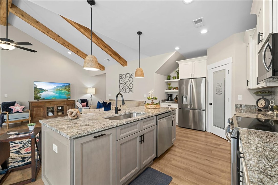 6834 Midway Road Pelzer, SC 29669 - Photo 12 of 50 This open concept kitchen features abundant workspace and storage, flowing seamlessly into the living area.