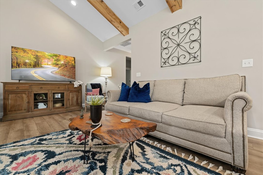 6834 Midway Road Pelzer, SC 29669 - Photo 13 of 50 This inviting living space features vaulted ceilings and wood beam accents.
