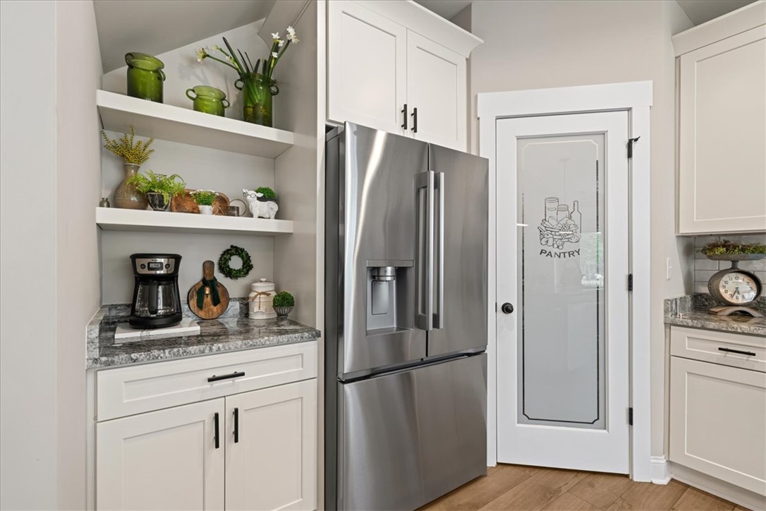 6834 Midway Road Pelzer, SC 29669 - Photo 15 of 50 This modern kitchen features a spacious pantry and gleaming stainless steel appliances.