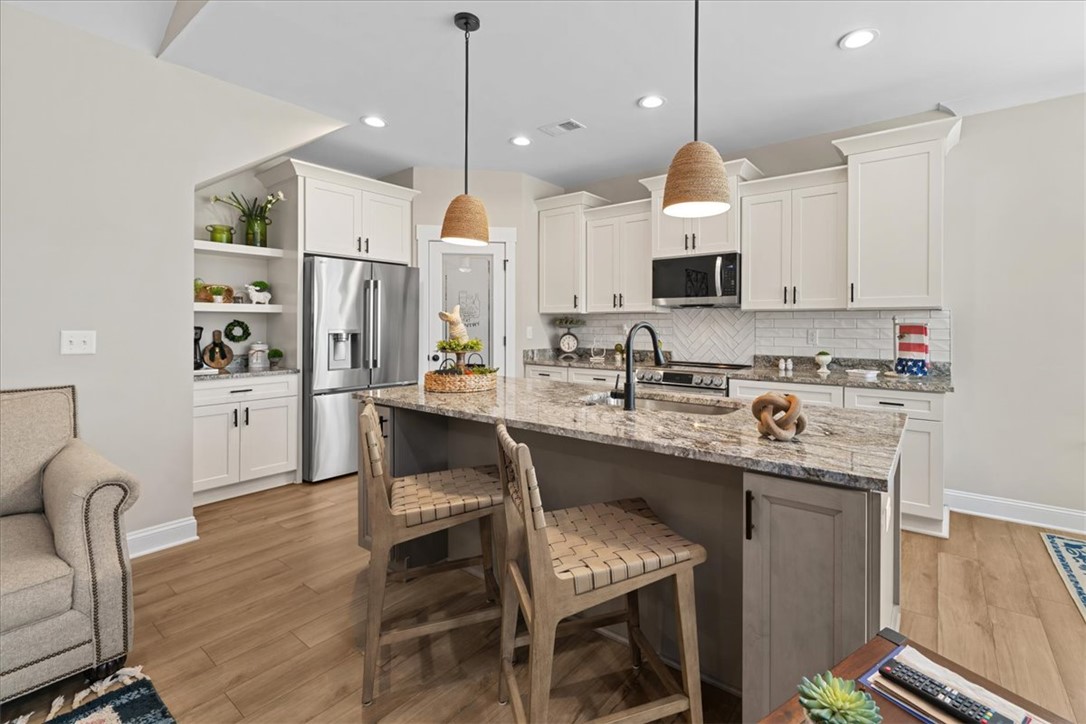 6834 Midway Road Pelzer, SC 29669 - Photo 17 of 50 This kitchen features a central island, recessed lighting, and a seamless flow into the living area.