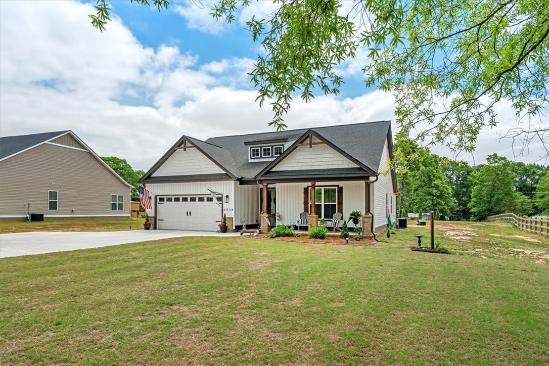6834 Midway Road Pelzer, SC 29669 - Photo 2 of 50 This charming residence features a classic facade and a spacious, verdant lawn perfect for outdoor enjoyment.