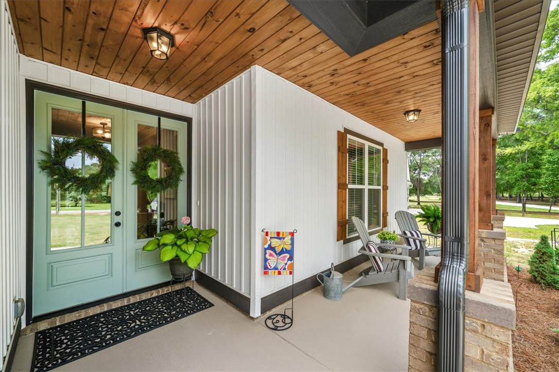 6834 Midway Road Pelzer, SC 29669 - Photo 3 of 50 This inviting porch offers a tranquil retreat with ample space for relaxation and enjoyment.