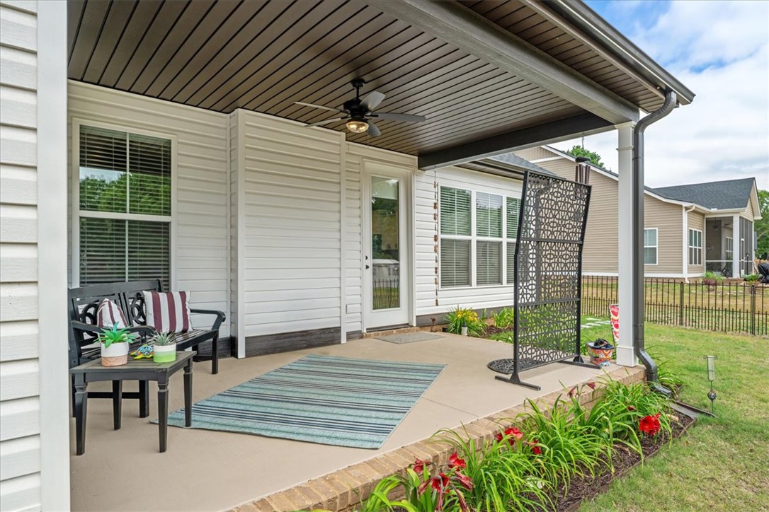 6834 Midway Road Pelzer, SC 29669 - Photo 45 of 50 This inviting patio area features a ceiling fan, perfect for enjoying the outdoors in comfort.