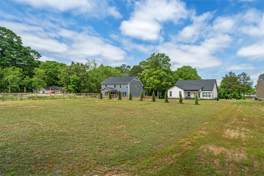 6834 Midway Road Pelzer, SC 29669 - Photo 46 of 50 This spacious lot offers ample room for outdoor activities and future expansion, surrounded by mature trees.