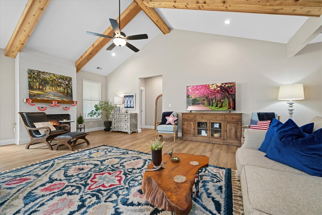 6834 Midway Road Pelzer, SC 29669 - Photo 6 of 50 This inviting living space features soaring ceilings and a cozy fireplace, perfect for gatherings.