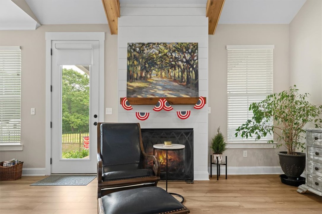 6834 Midway Road Pelzer, SC 29669 - Photo 9 of 50 This bright living space features exposed beams and a charming fireplace.