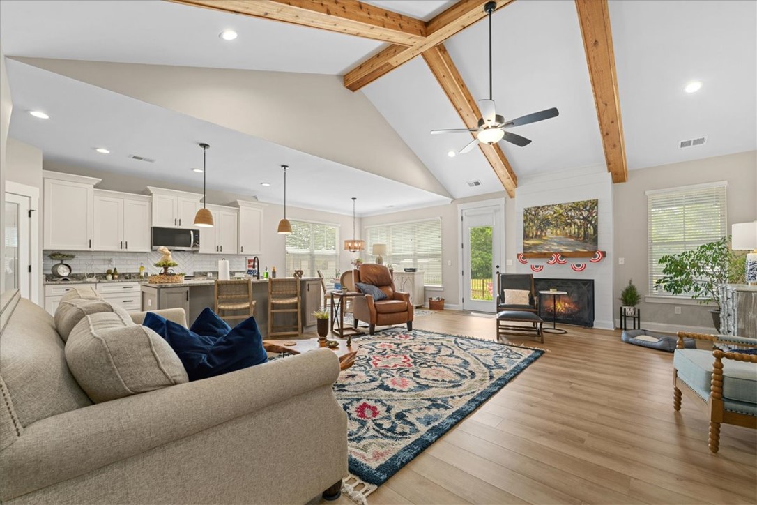 6834 Midway Road Pelzer, SC 29669 - Photo 10 of 50 This bright and open living space features high ceilings and a cozy fireplace.