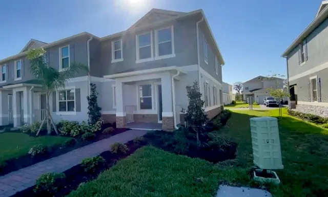 a view of a big yard in front of a brick building
