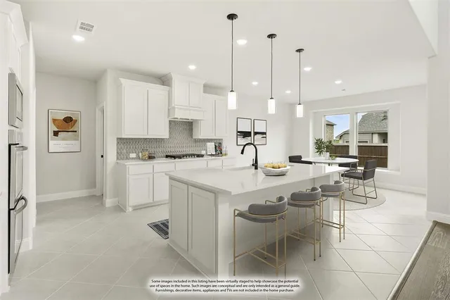 a large kitchen with kitchen island a table and chairs