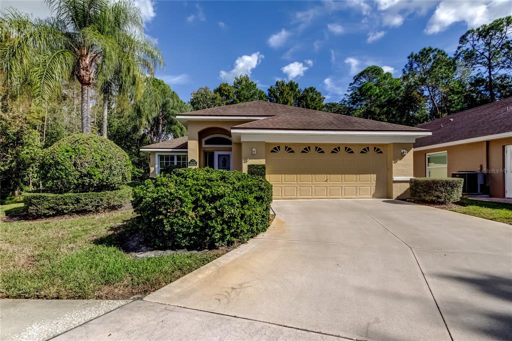 a front view of a house with a yard and potted plants