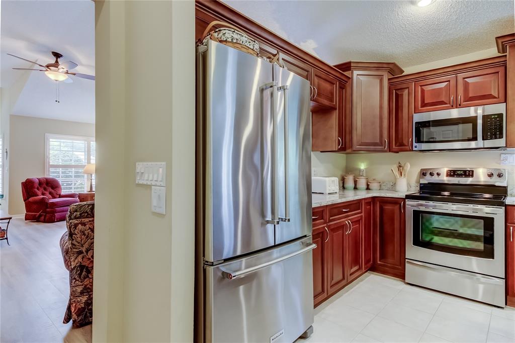 1610 Cortleigh Drive Trinity, FL 34655 - Photo 14 of 72 a kitchen with stainless steel appliances granite countertop a refrigerator stove and sink