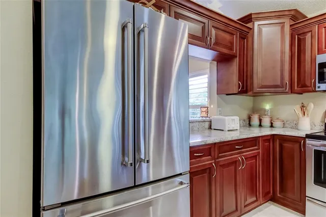 a kitchen with granite countertop stainless steel appliances a stove a sink and a microwave
