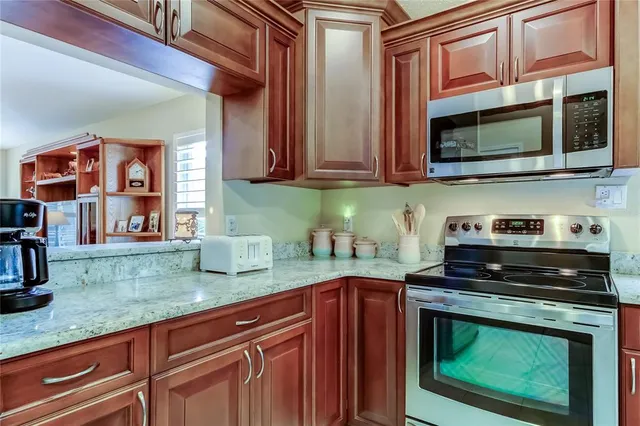 a kitchen with stainless steel appliances granite countertop a refrigerator and a sink