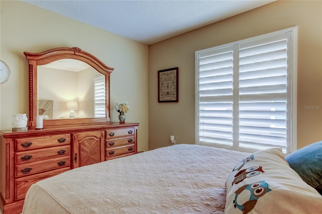 1610 Cortleigh Drive Trinity, FL 34655 - Photo 29 of 72 a bedroom with a bed and a mirror on dresser