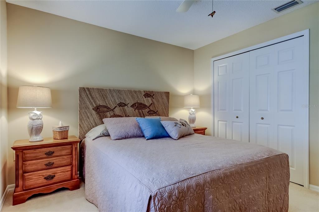 1610 Cortleigh Drive Trinity, FL 34655 - Photo 30 of 72 a bedroom with a bed and a lamp