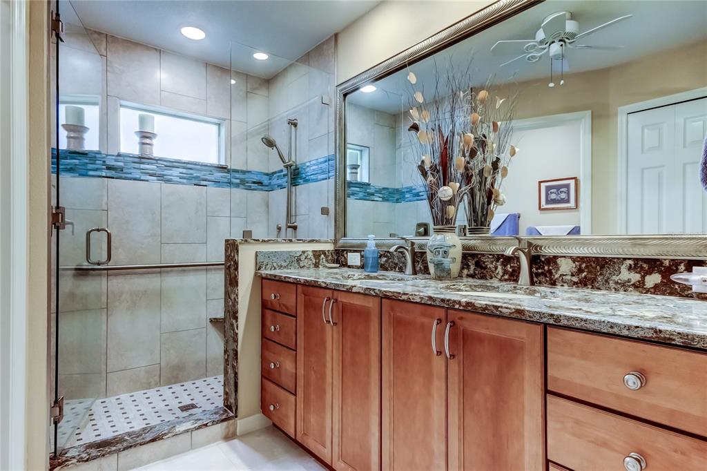 1610 Cortleigh Drive Trinity, FL 34655 - Photo 40 of 72 a bathroom with a granite countertop sink mirror and shower