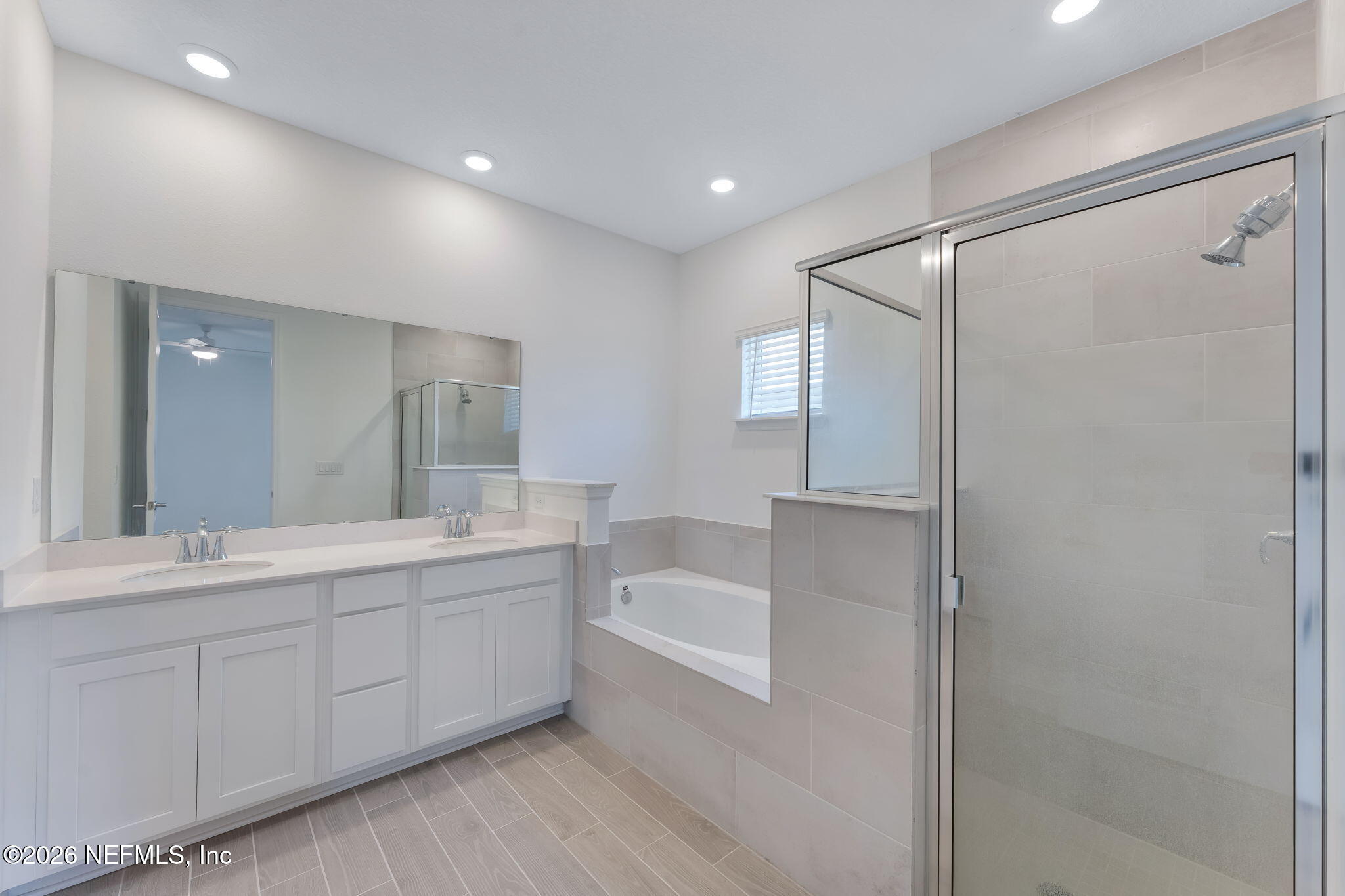 75776 Estuary Way Yulee, FL 32097 - Photo 12 of 20 a bathroom with a double vanity sink and mirror with shower
