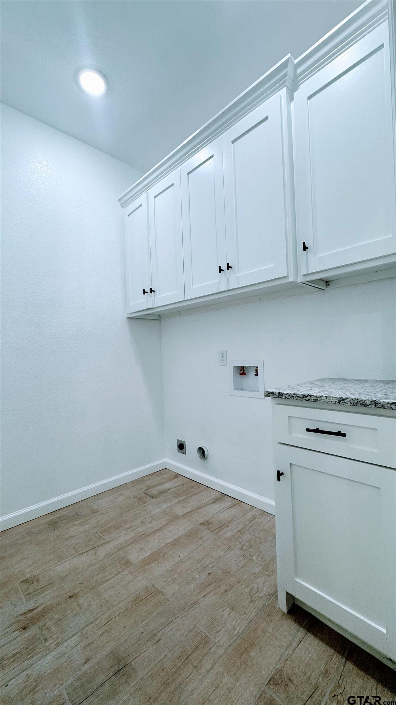 20428 High Point Drive Flint, TX 75762 - Photo 14 of 18 a kitchen with white cabinets and a stove