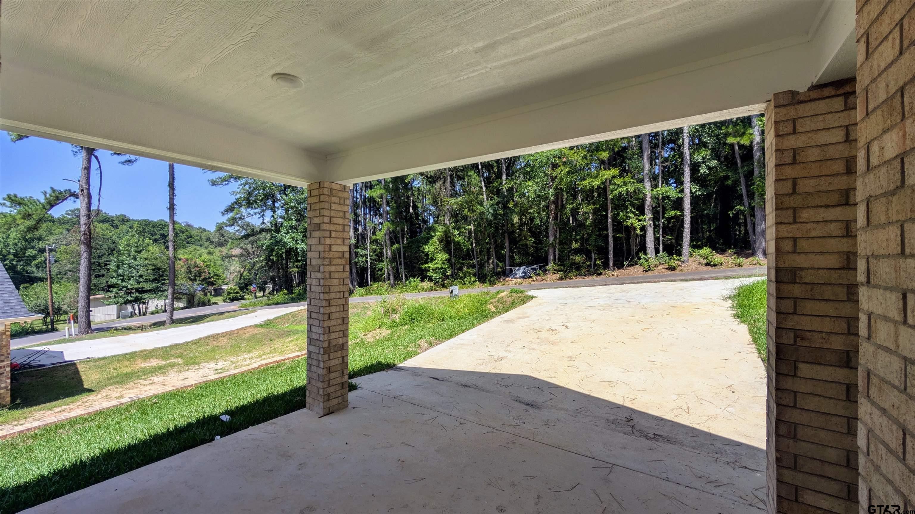 20428 High Point Drive Flint, TX 75762 - Photo 17 of 18 a view of a house with a floor to ceiling window and a yard