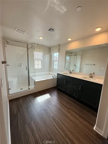 a bathroom with a double vanity sink and a mirror