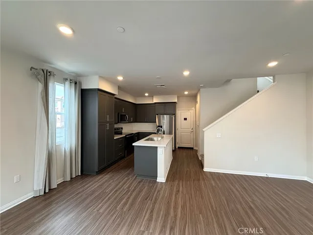 a view of a kitchen with a sink and a refrigerator