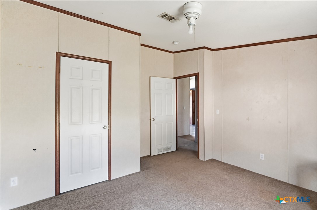 780 Oak Tree Road Seguin, TX 78155 - Photo 12 of 40 a view of a room with a chandelier fan and closet